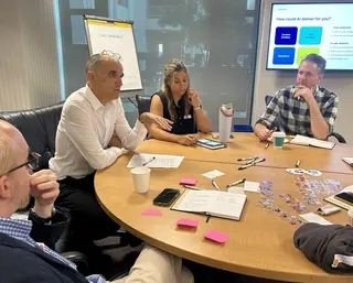 Participants at the 2025 Not-a-Bot summit discuss AI around a table