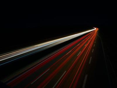 Blurred car head and tail lights indicating speed.