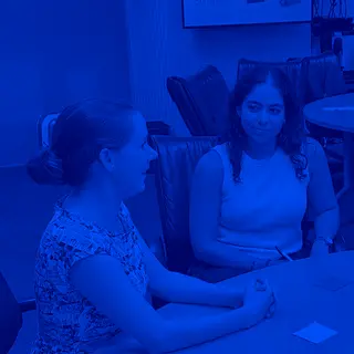 Two Capellic strategists talking at a conference table